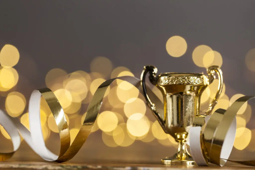gold award trophy against bright blurred lights 2024 09 12 00 15 17 utc
